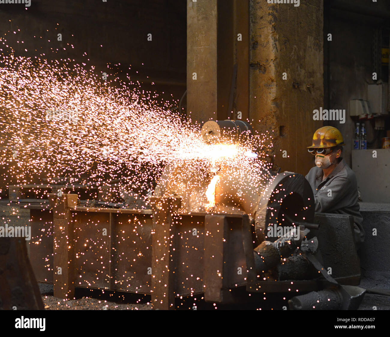 Berlin, Germany - April 18, 2013: Production of metal components in a foundry - worker Stock Photo
