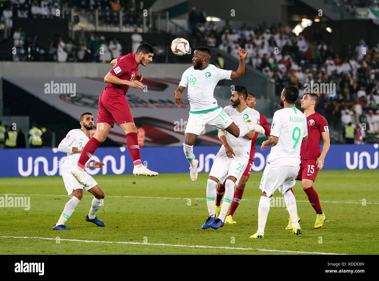 17th January 2019, Zayed Sports City Stadium, Abu Dhabi, United Arab Emirates; AFC Asian Cup football, Saudi Arabia versus Qatar; Akram Afif of Qatar heading the ball away in front of Fahad Al-Muwallad of Saudi Arabia Stock Photo