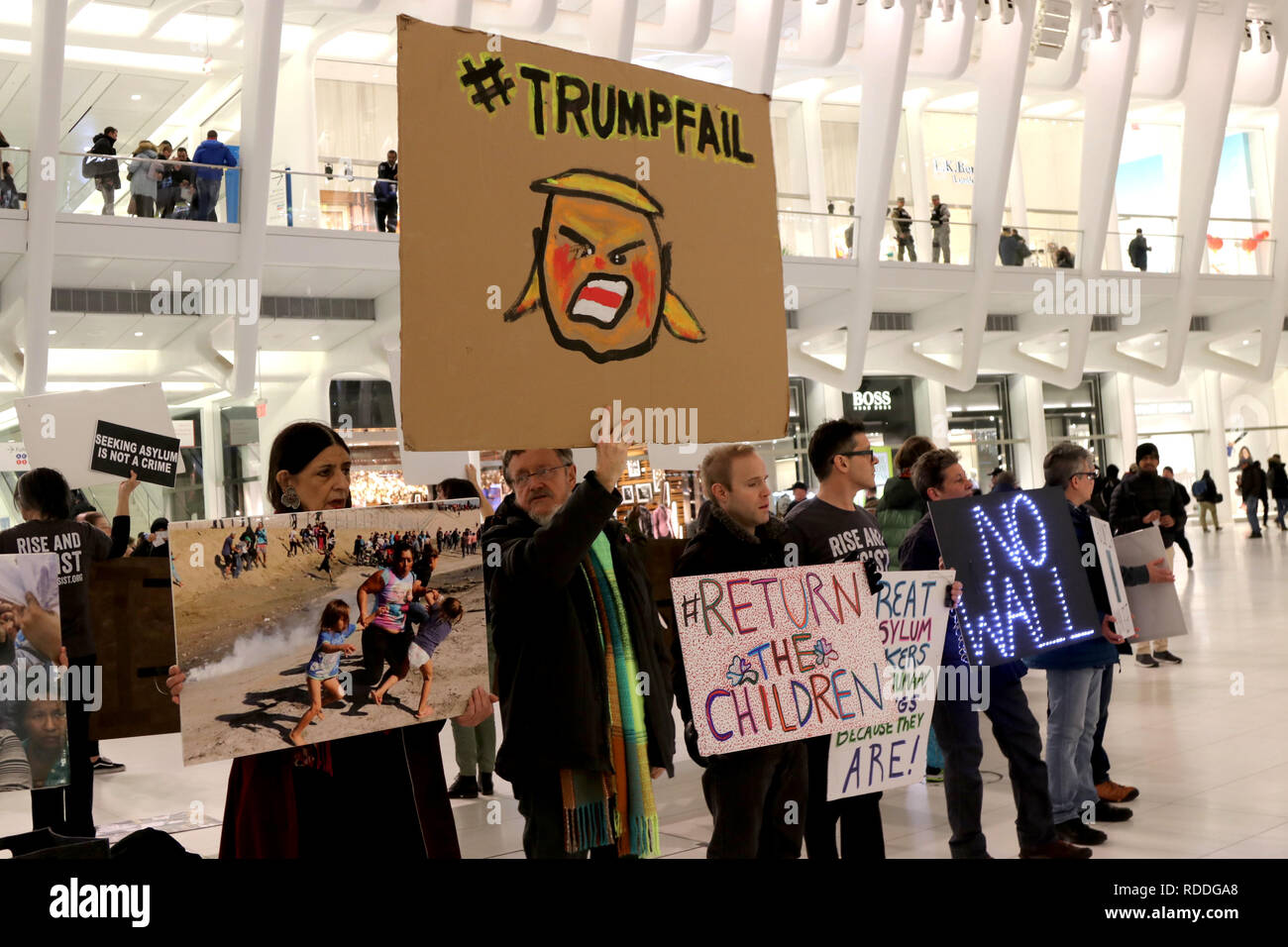 January 17, 2019 - New York City, New York, US - Advocacy group Rise and Resist staged a silent protest in The Oculus transit hub during rush hour on 17 January, 2019. The protesters stood in silence with their banners and placards drawing the attention of commuters to the Donald Trump's administration U.S. border policy of child separation and detention. Highlighting that Seeking Asylum Is Not A Crime and that there is no national security emergency on the border, instead, there is a humanitarian emergency that can not be remedied by building a wall. (Credit Image: © G. Ronald Lopez/ZUMA Wi Stock Photo