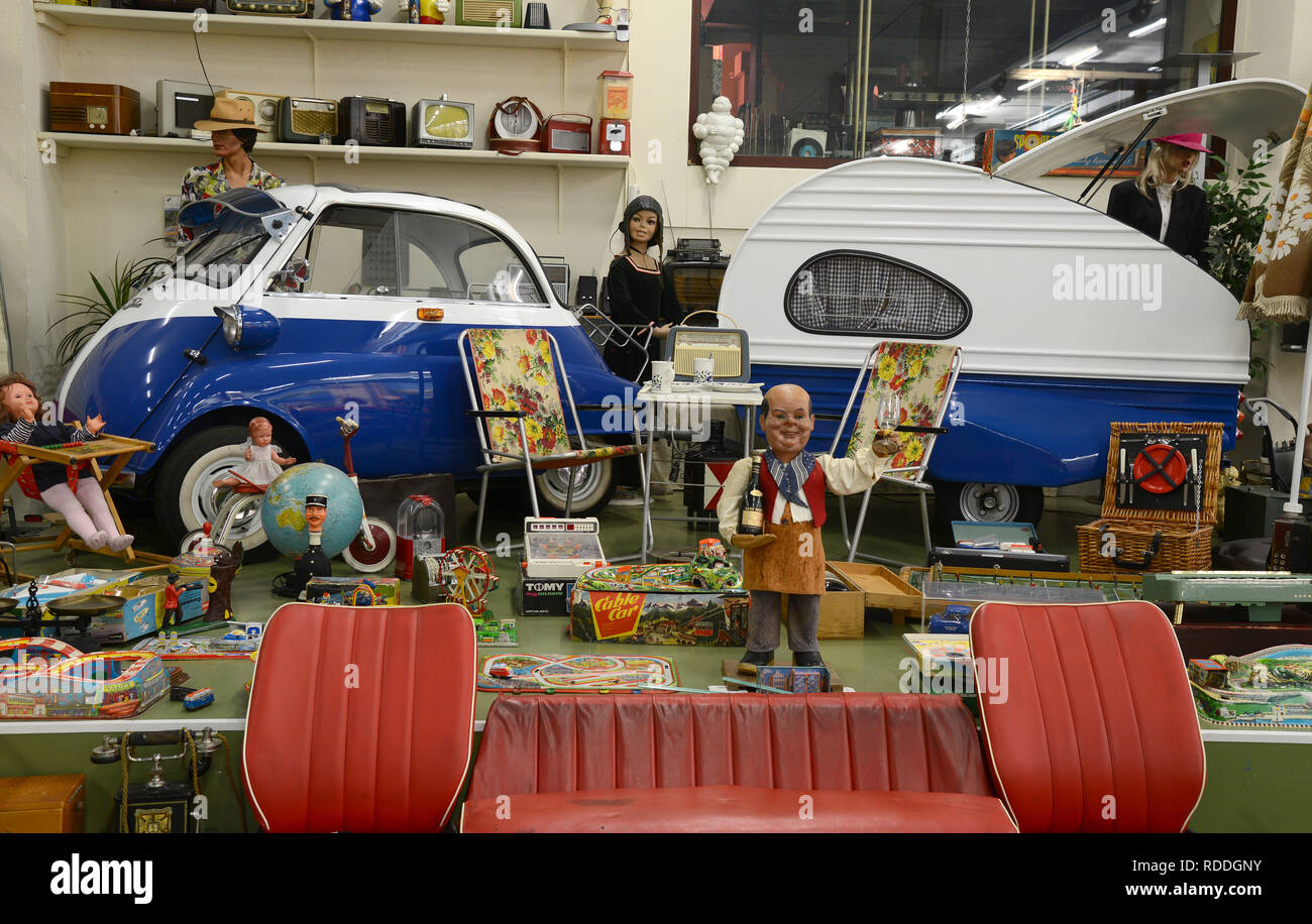 St. Ingbert, Germany. 14th Jan, 2019. A BMW Isetta with a caravan from the early days of the Federal Republic of Germany is standing in the hall of engineer Stefan Voit in Saarland. 25 years ago the engineer fell in love with a Messerschmitt cab scooter at a motorcycle trade fair in Saarbrücken and has since collected a private collection of a total of 120 small cars and scooters. (to dpa 'Saarlander collects car-windlings from past times') Credit: Harald Tittel/dpa/Alamy Live News Stock Photo