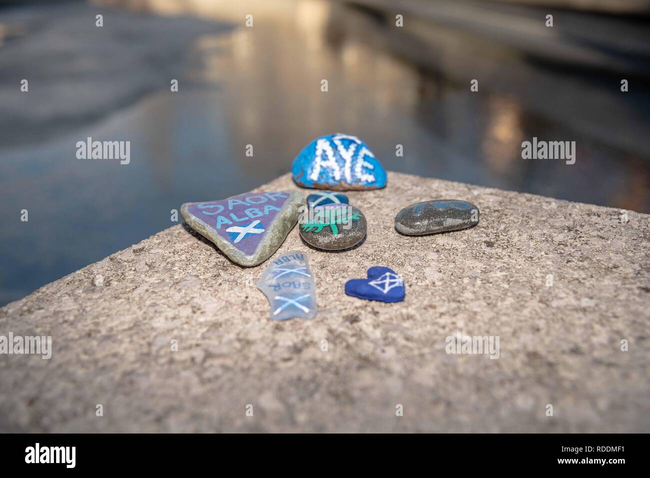 A collection of decorated pebbles seen on a seat outside the Scottish Parliament. Protesters gathered outside Scottish Parliament building in Edinburgh to protest Brexit and to push for a second independence referendum. Stock Photo