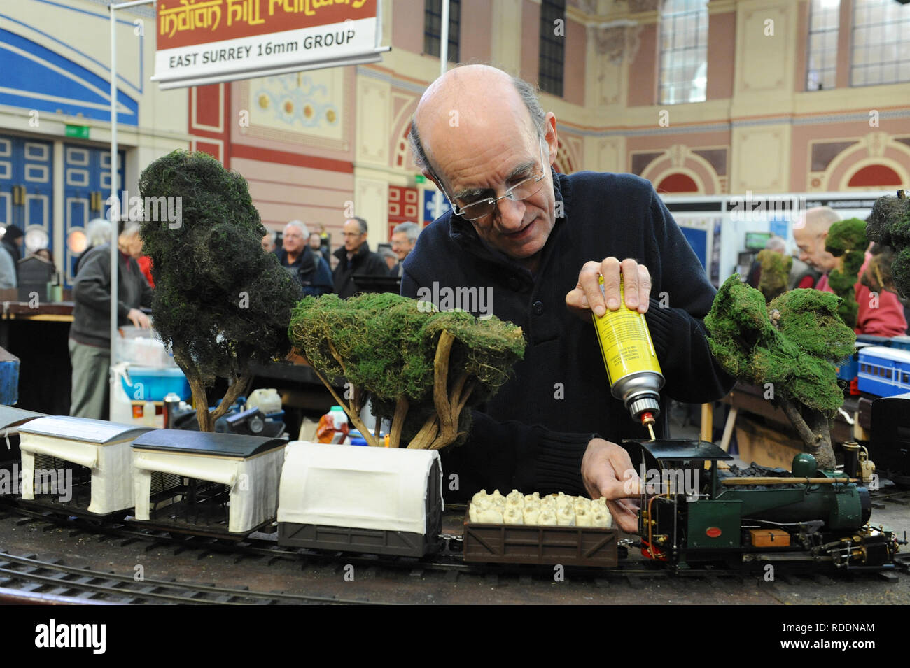 London, UK. 18th Jan 2019. A man getting preparing a 16mm narrow gauge train at the London Model Engineering Exhibition which opened today at Alexandra Palace, London.  The London Model Engineering Exhibition is now in its 23rd year, and attracts around 14,000 visitors.  The show offers a showcase to the full spectrum of modelling from traditional model engineering, steam locomotives and traction engines through to the more modern gadget and boys toys including trucks, boats, aeroplanes and helicopters. Credit: Michael Preston/Alamy Live News Stock Photo