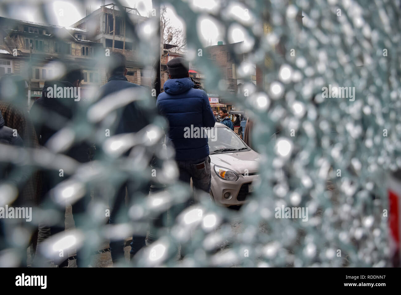 January 18, 2019 - Srinagar, Jammu & Kashmir, India - Kashmiri men seen standing in front of a broken glass of a shop next to the site of explosion at city centre Lal chowk Srinagar. Credit: Idrees Abbas/SOPA Images/ZUMA Wire/Alamy Live News Stock Photo