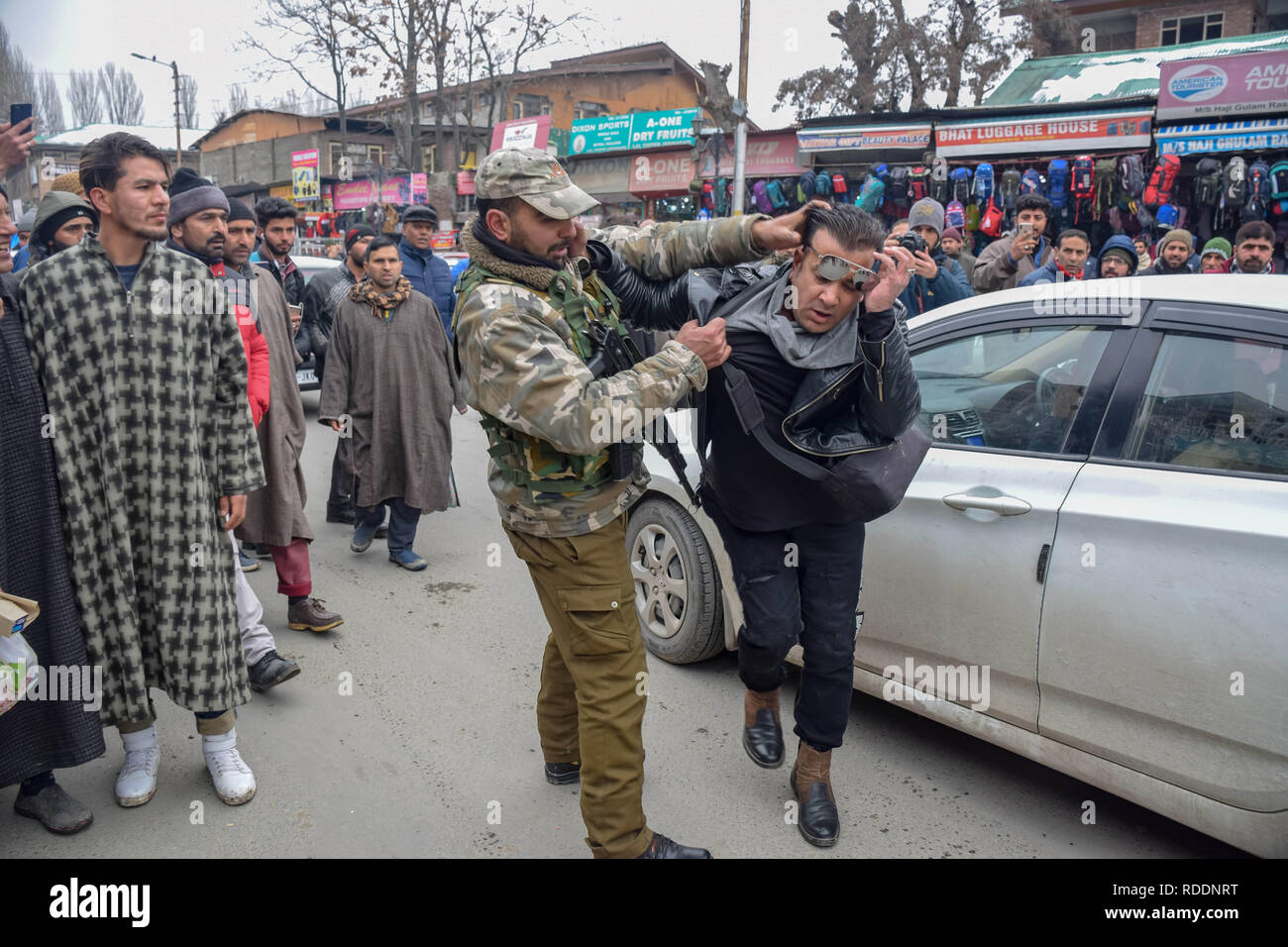 January 18, 2019 - Srinagar, Jammu & Kashmir, India - Members Of Jammu and Kashmir police seen detaining a man next to the site of explosion in Srinagar. Credit: Idrees Abbas/SOPA Images/ZUMA Wire/Alamy Live News Stock Photo