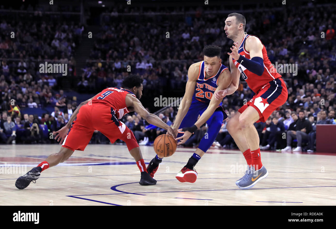 New York Knicks' Kevin Knox (centre) is tackled by Washington Wizards' Chasson Randle (left) and Washington Wizards' Sam Dekker during the NBA London Game 2019 at the O2 Arena, London. Stock Photo