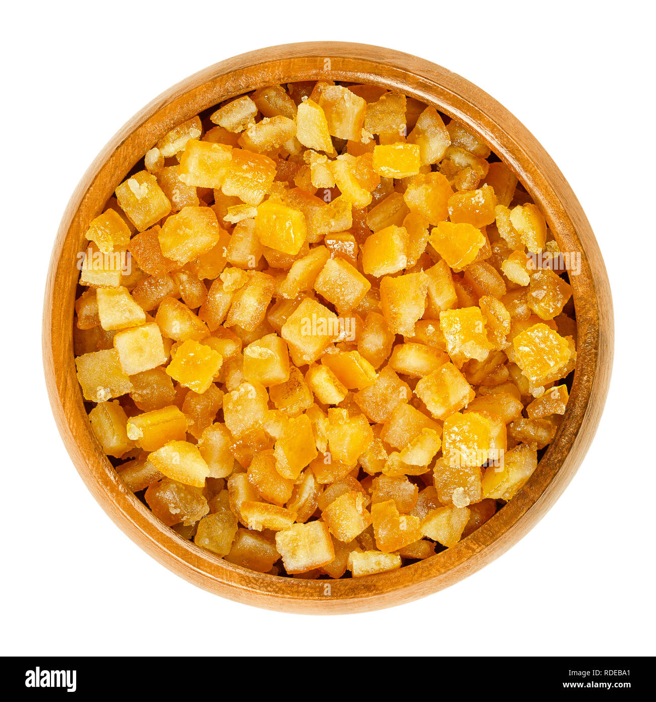 Candied orange peel in wooden bowl. Diced, preserved and crystallized peel of oranges in sugar syrup, often used in cakes as filling. Stock Photo