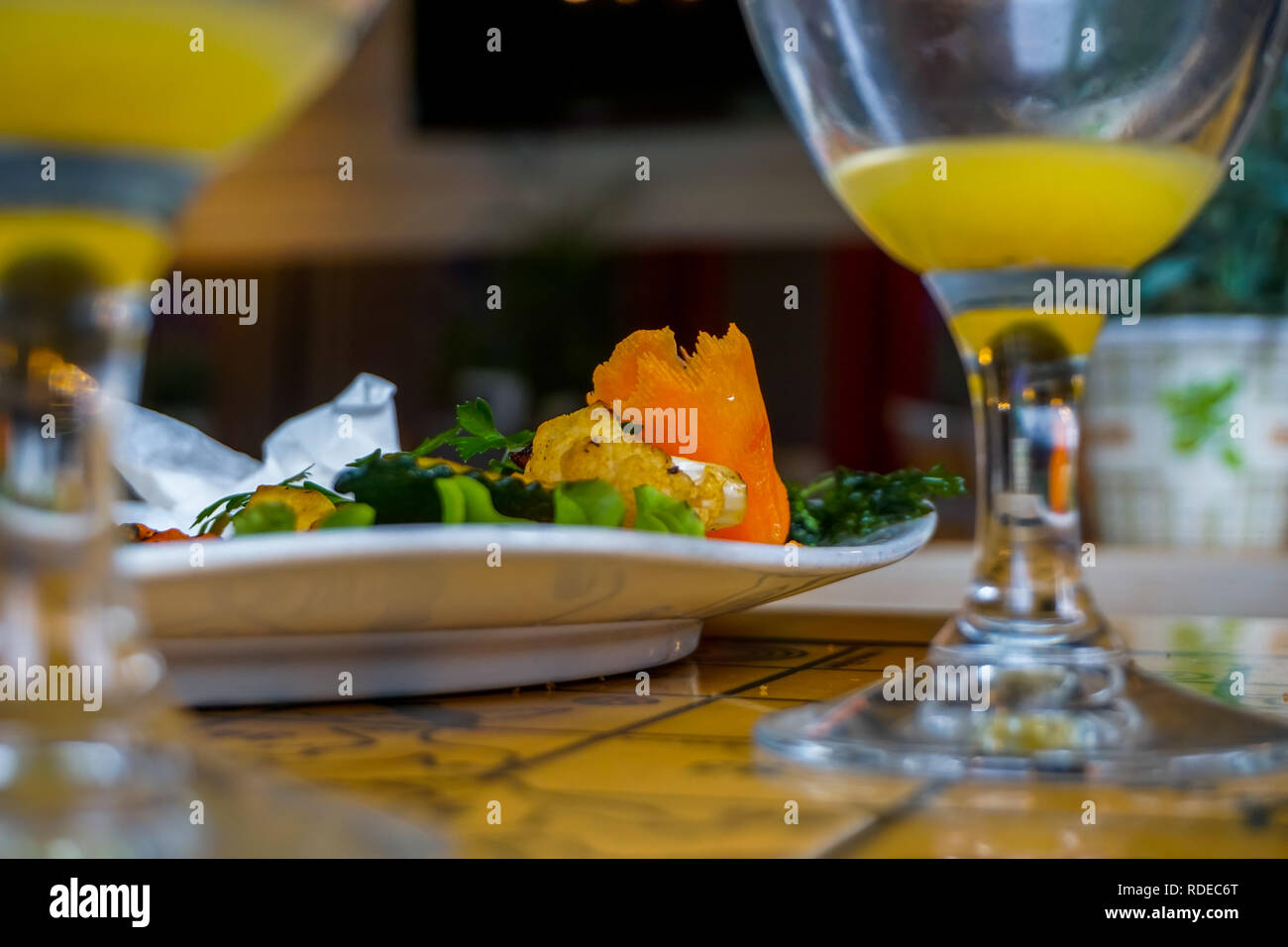 Plate with salmon salad and orange juice. Lunch in cafe Liepkalni, Latvia. Dinner in cafe. Stock Photo