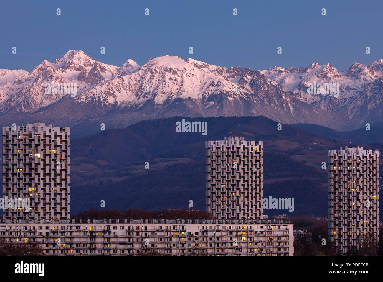 Grenoble, France, January 2019 : the three towers in front the belledonne mountains at sunset, ile verte neighbourhood. Stock Photo