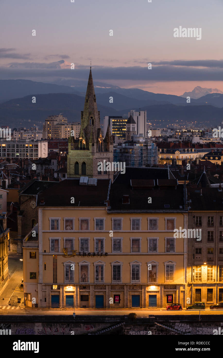 Grenoble, France, January 2019 : Theatre and Saint Andre church at sunset with mountains in the background. Stock Photo