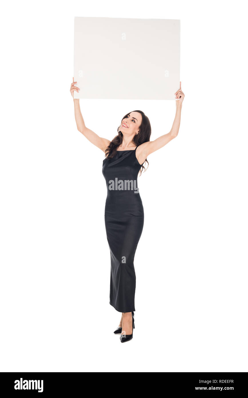 elegant woman in black dress posing with blank placard isolated on white Stock Photo