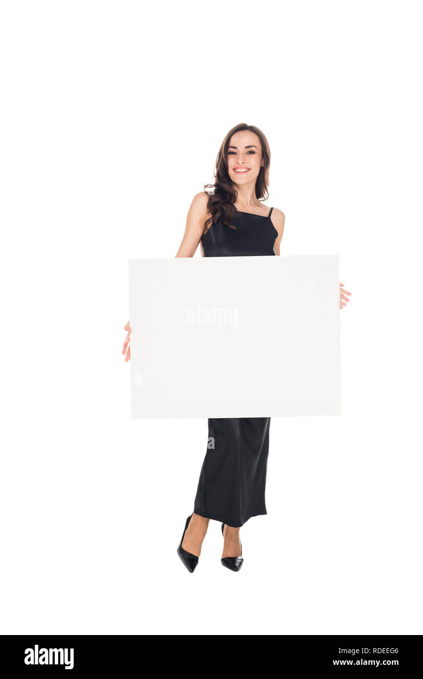 smiling elegant woman in black dress posing with empty board isolated on white Stock Photo