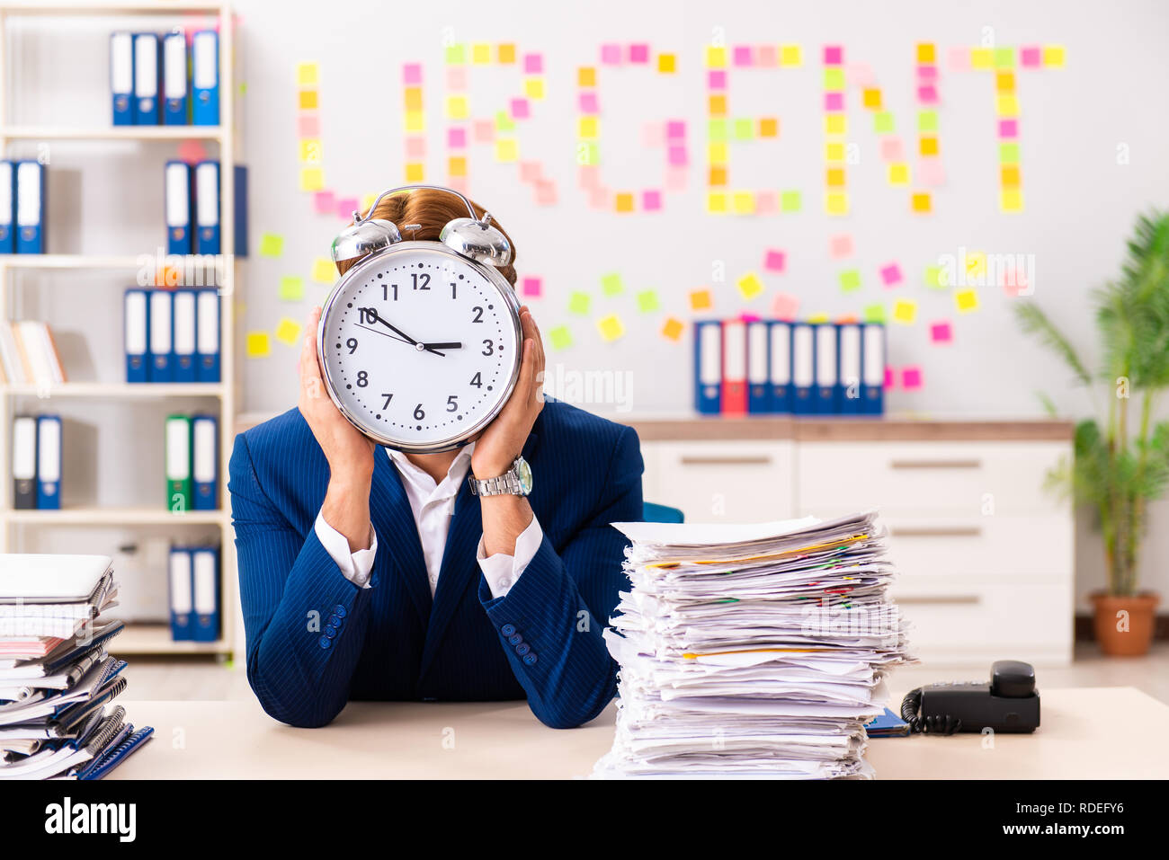 Young employee suffering from excessive work Stock Photo