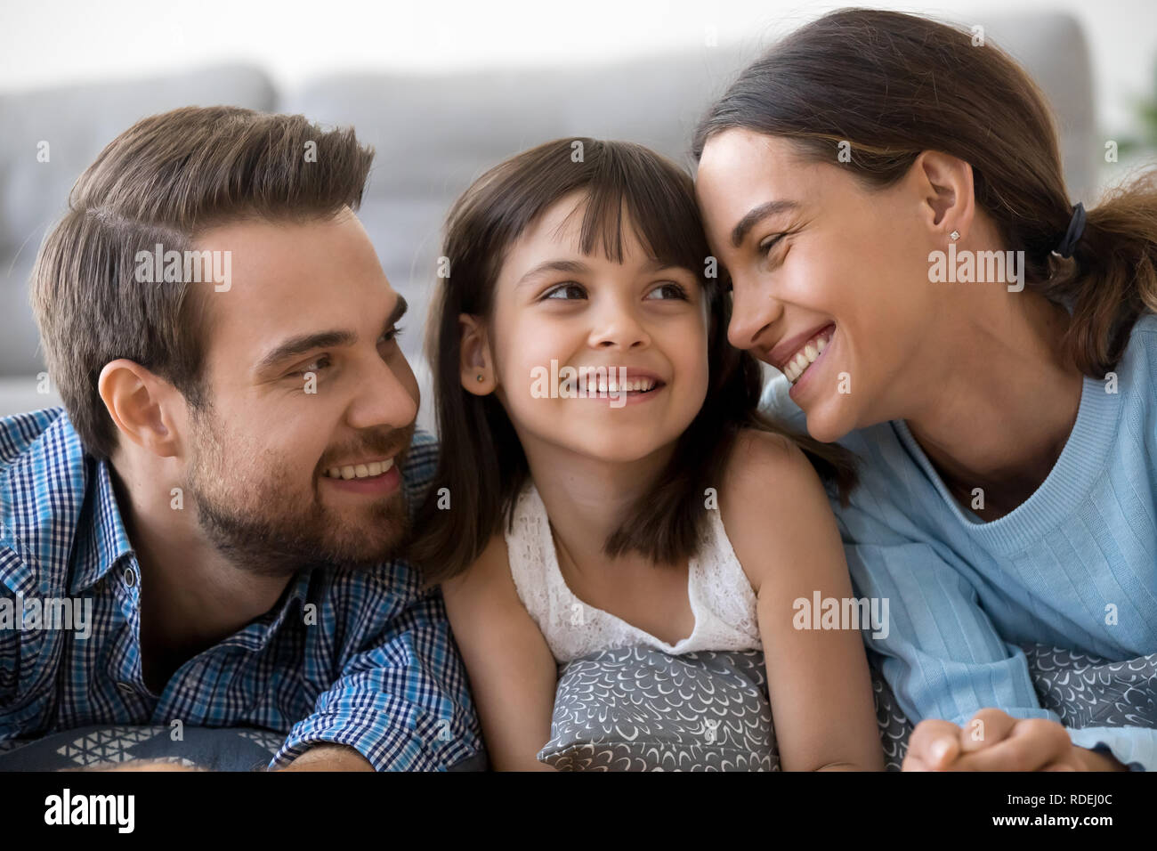 Child girl feeling happy having fun with loving caring parents Stock Photo