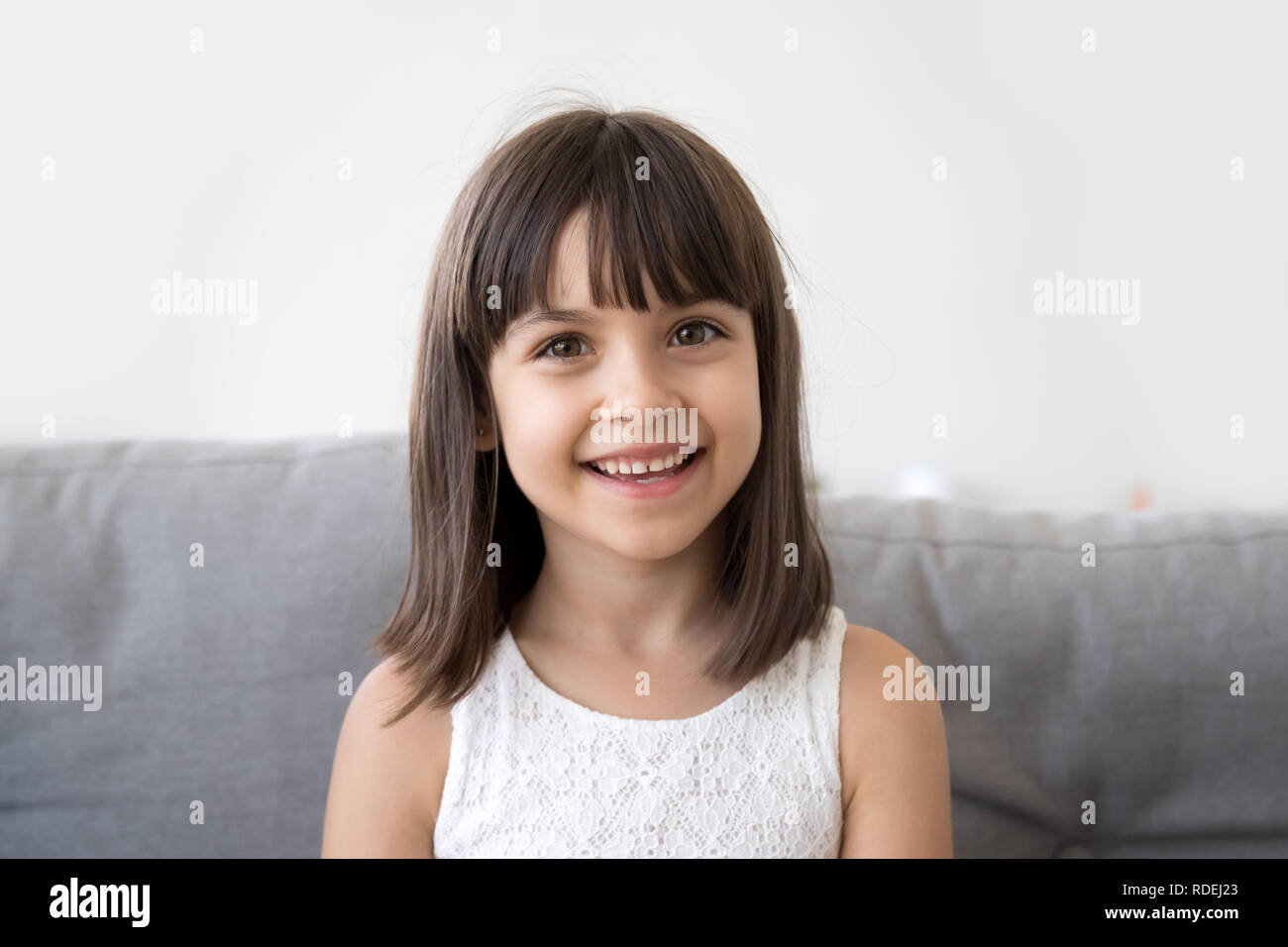 Smiling child girl talking to camera making video call vlog Stock Photo