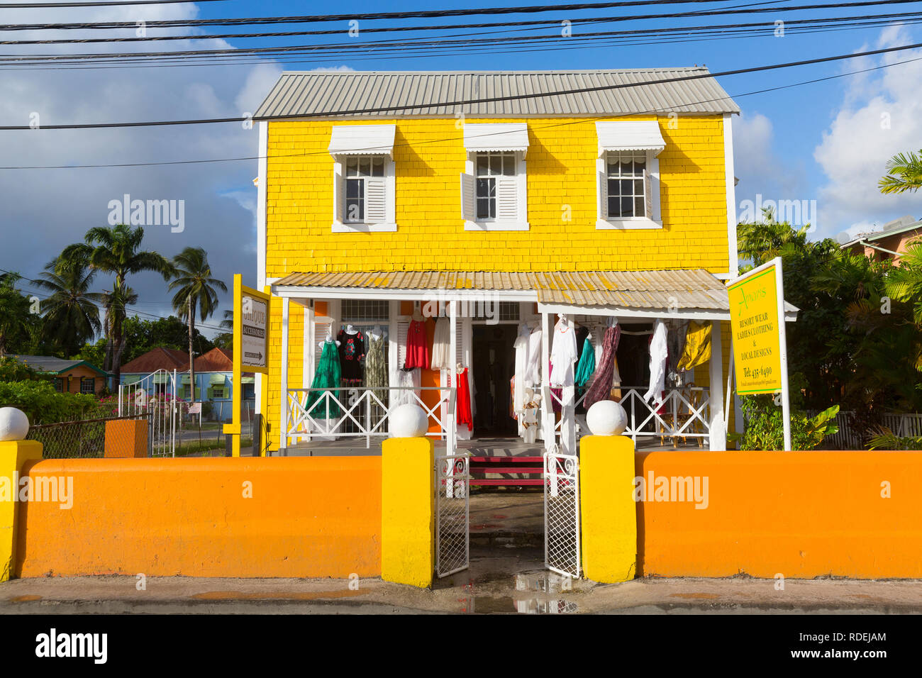 Yellow painted beach house on barbados hires stock photography and