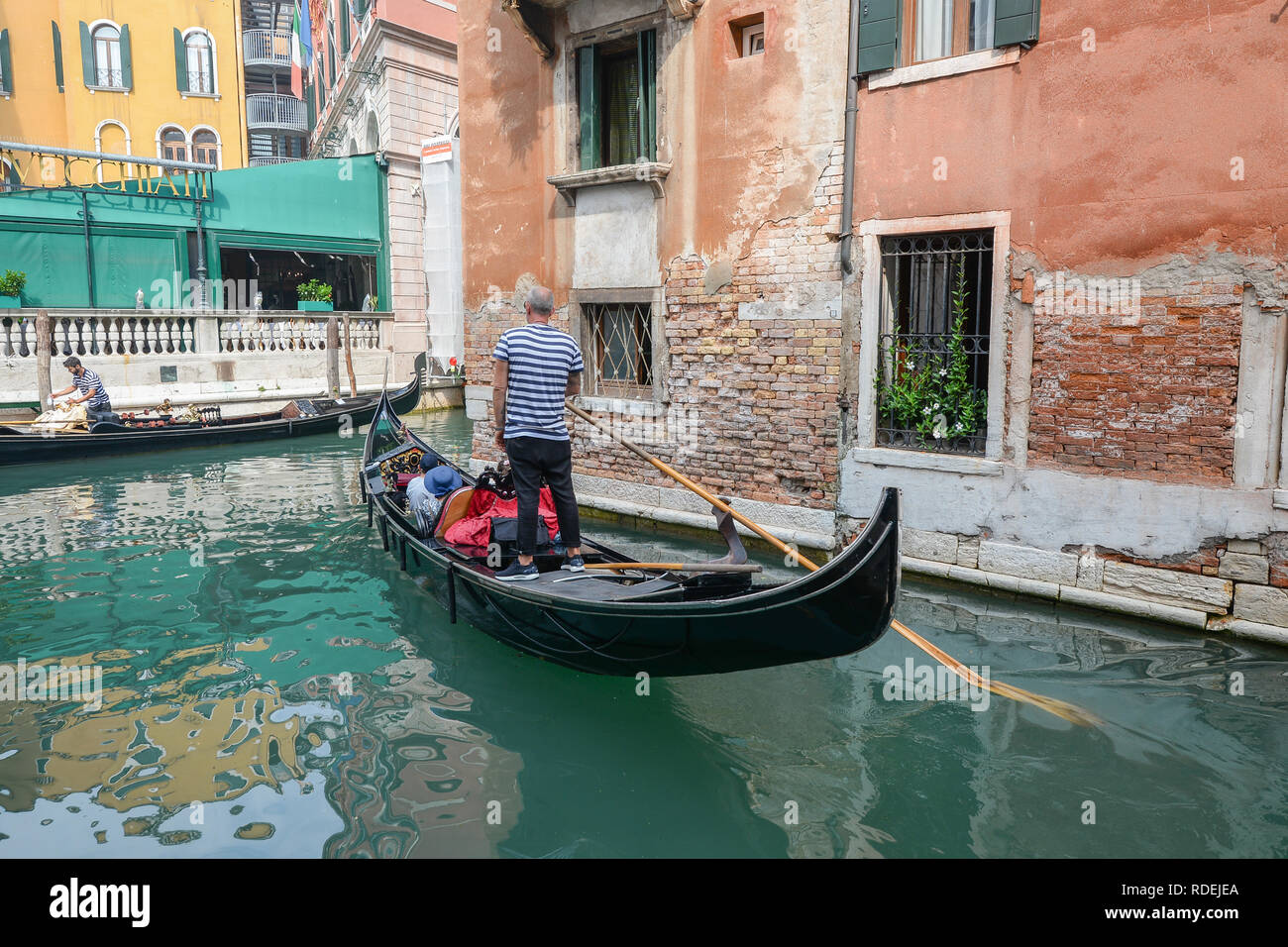 canal in Venice and gondolier Stock Photo