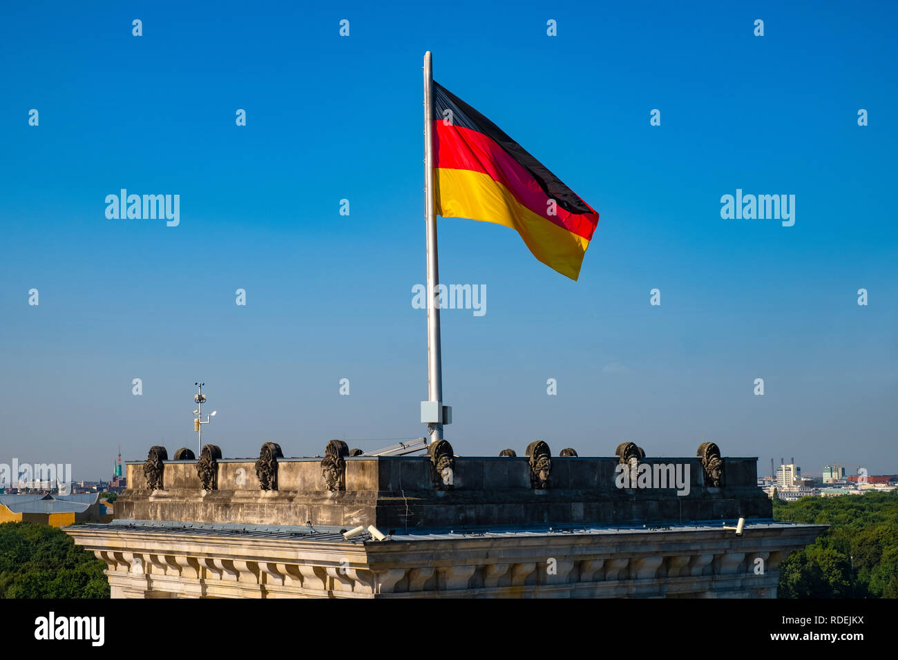 Berlin, Berlin state / Germany - 2018/07/31: Rooftop of the Reichstag building with the historic corner tower and Germany flag with Berlin skyline Stock Photo