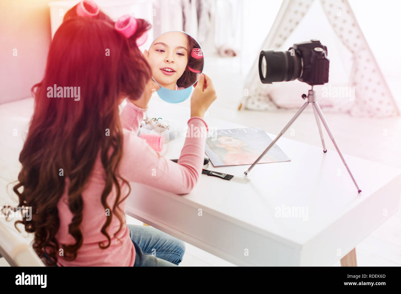 Little beautiful girl making little video presentation participating in beauty contest Stock Photo