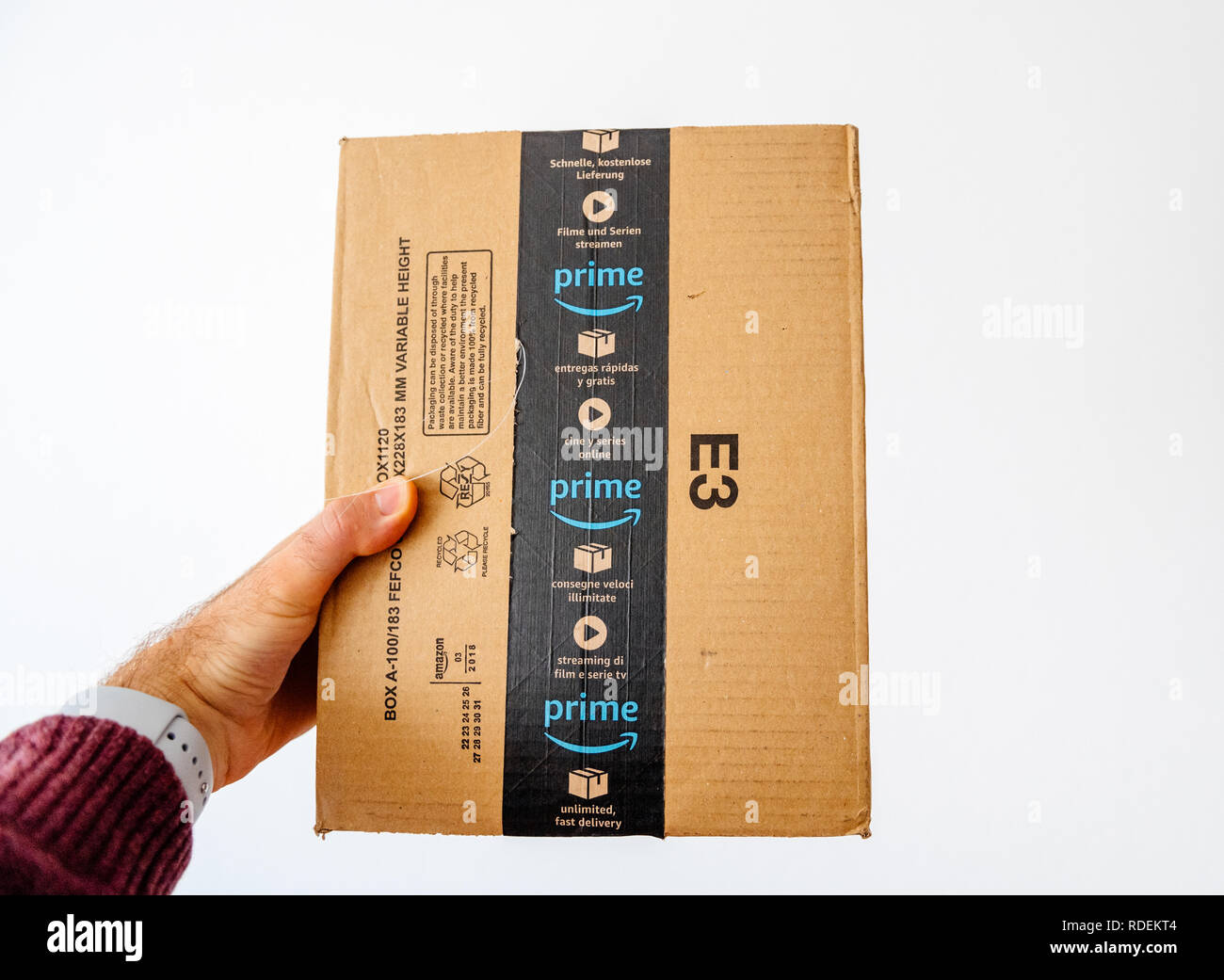 PARIS, FRANCE - APR 20, 2018: Male hand holding the Amazon cardboard box  parcel against white isolated background Stock Photo - Alamy