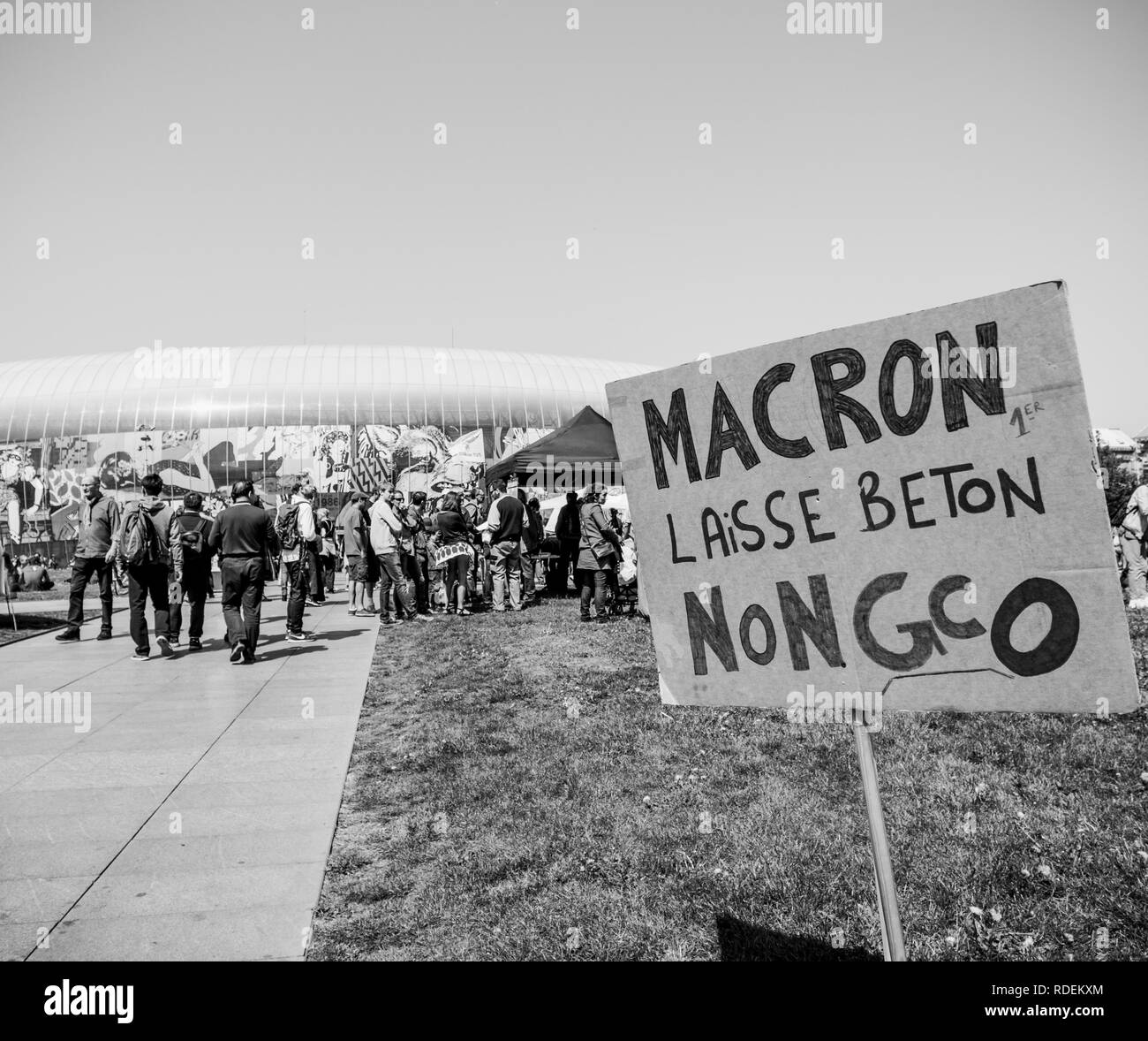 STRASBOURG, FRANCE - MAY 5, 2018: People making a party protest Fete a Macron party for Macron in front of Gare de Strasbourg againt grand contournement ouest de strasbourg - black and white  Stock Photo