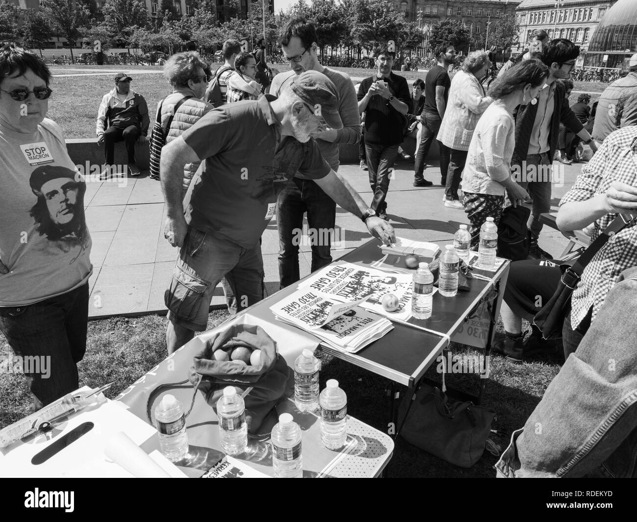 STRASBOURG, FRANCE - MAY 5, 2018: People making a party protest Fete a Macron in front of Gare de Strasbourg - people seniors taking flyers from table Stock Photo