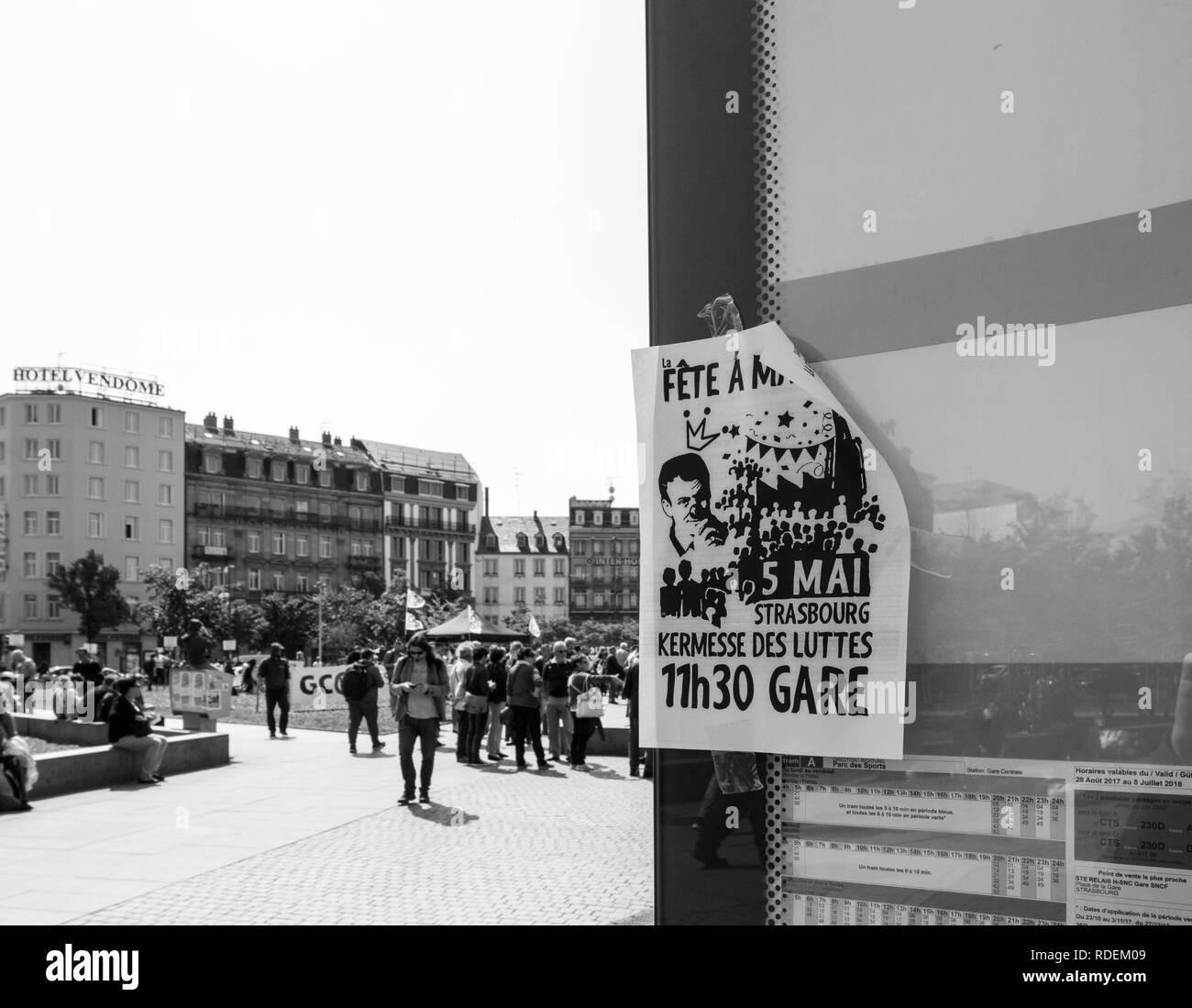 STRASBOURG, FRANCE - MAY 5, 2018: People making a party protest Fete a Macron in front of Gare de Strasbourg  poster calling to party  Stock Photo