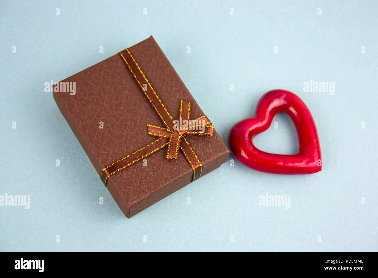 brown present box and red heart top view blu background Stock Photo