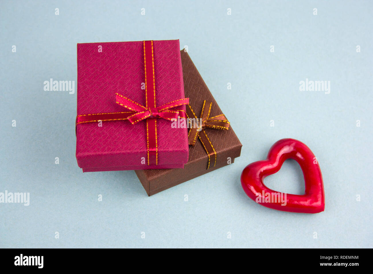 brownand red present boxes and red heart top view blu background Stock Photo