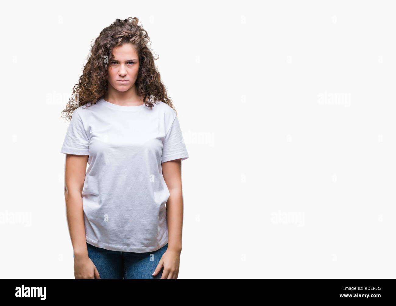 Beautiful brunette curly hair young girl wearing casual t-shirt over isolated background skeptic and nervous, frowning upset because of problem. Negat Stock Photo