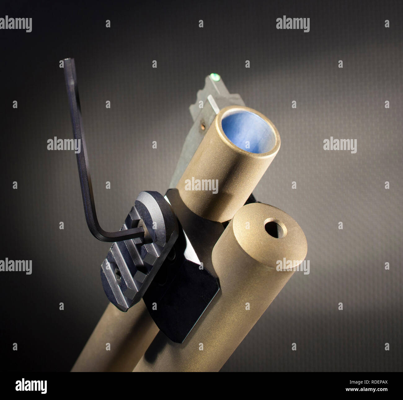 Tool being used to tighten a weaponlight rail adapter on a shotgun Stock Photo Alamy