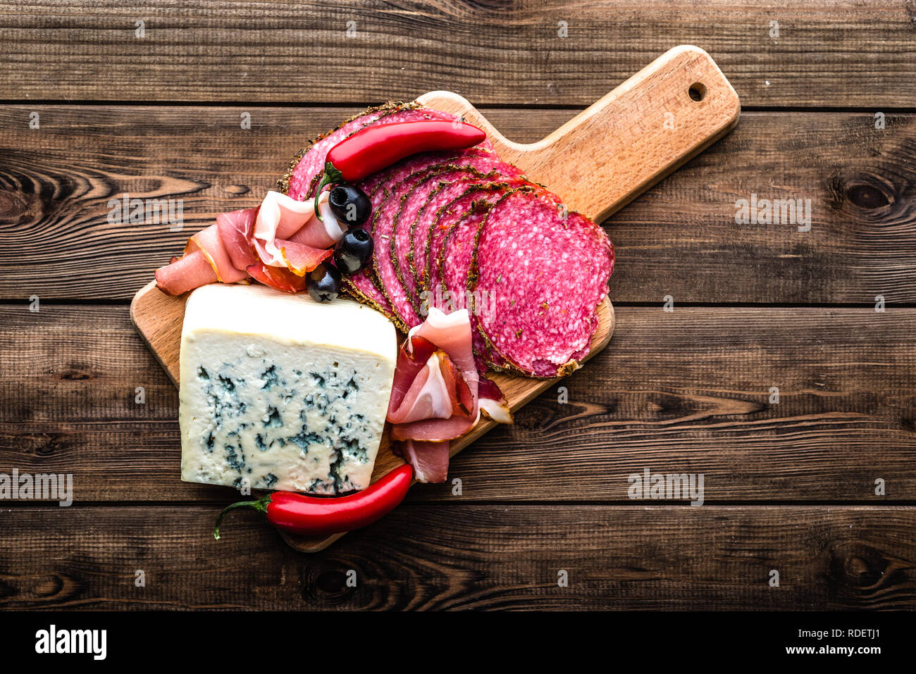 Blue cheese and cold meat platter with salami, slices ham prosciutto