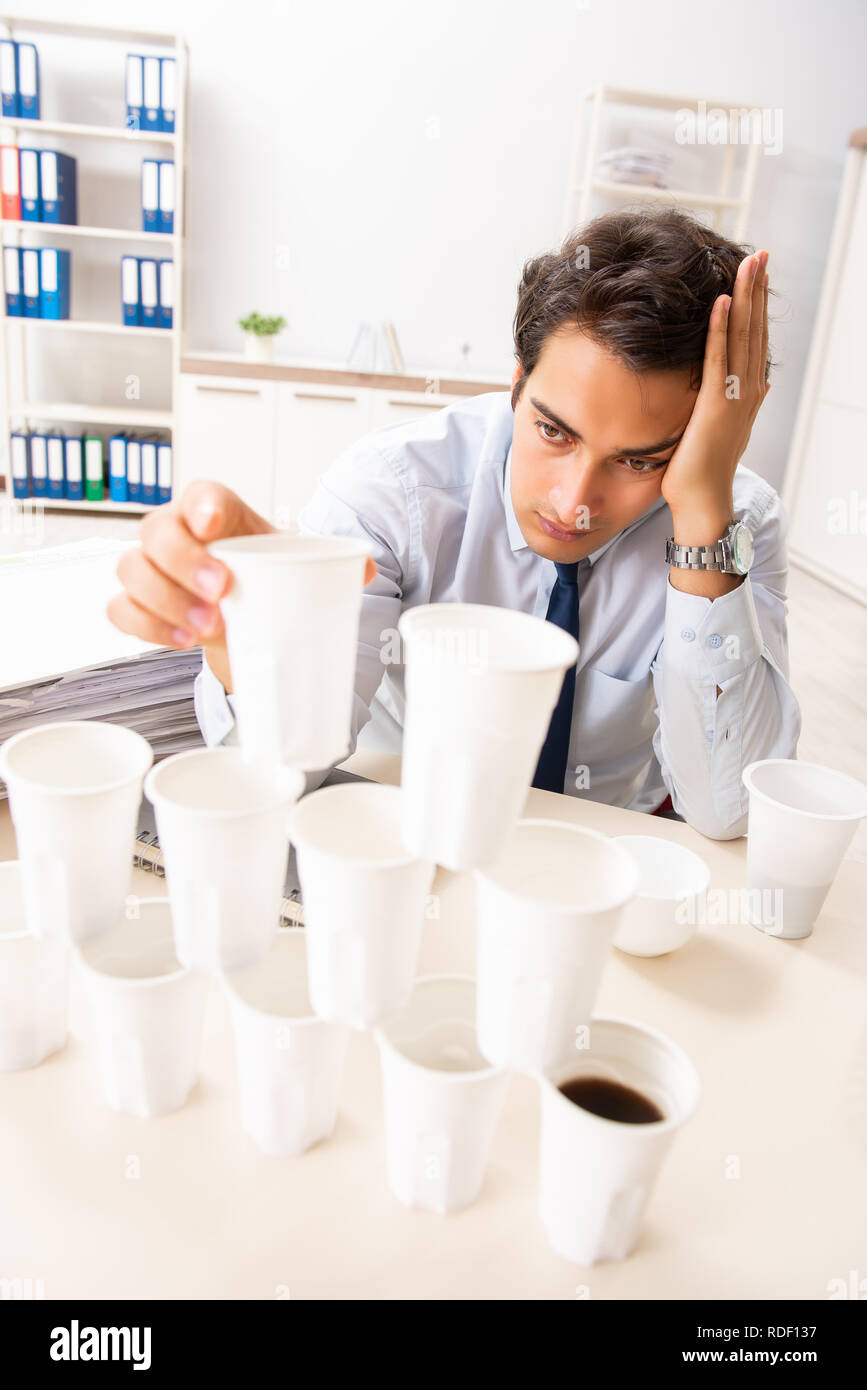 https://c8.alamy.com/comp/RDF137/young-employee-building-pyramid-from-plastic-cups-RDF137.jpg