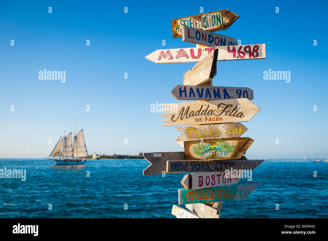 KEY WEST, FLORIDA, USA - JANUARY 13, 2019: A rustic wooden direction sign topped with the message #selfiemostpoint stands on Sunset Pier at Mallory Sq Stock Photo