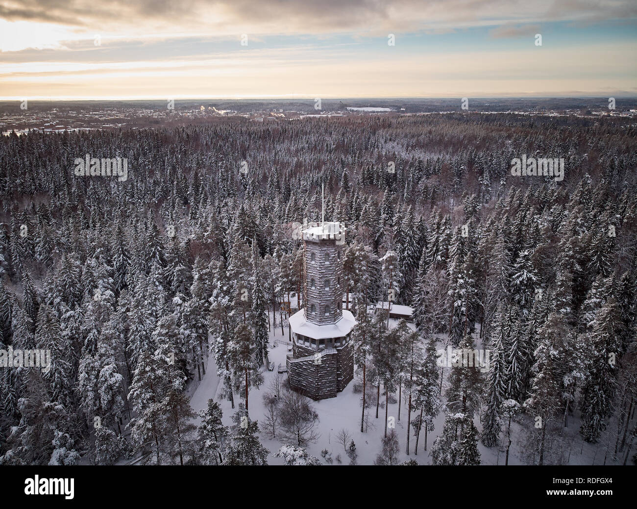 Aerial view of the lookout tower in winter landscape at Aulanko nature reserve park in Hämeenlinna, Finland. Frosty trees and snowy forest around an i Stock Photo