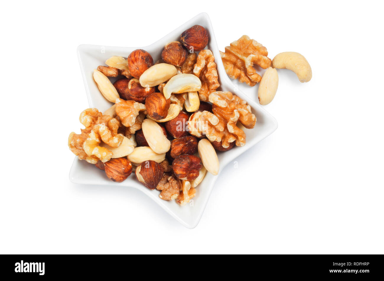 studio shot of mixed nuts isolated against a white background - John Gollop Stock Photo