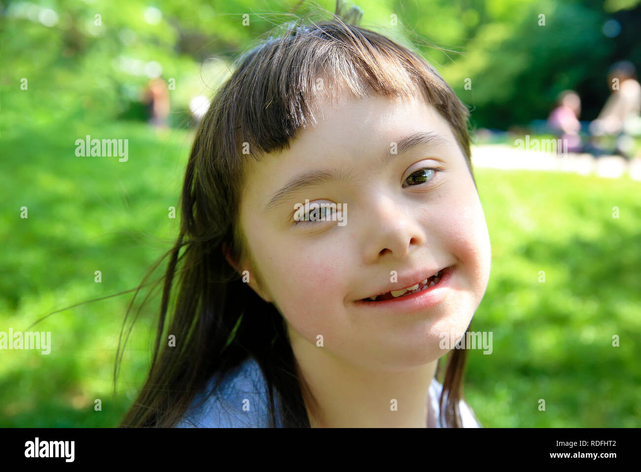 Portrait of little girl smiling in the park Stock Photo