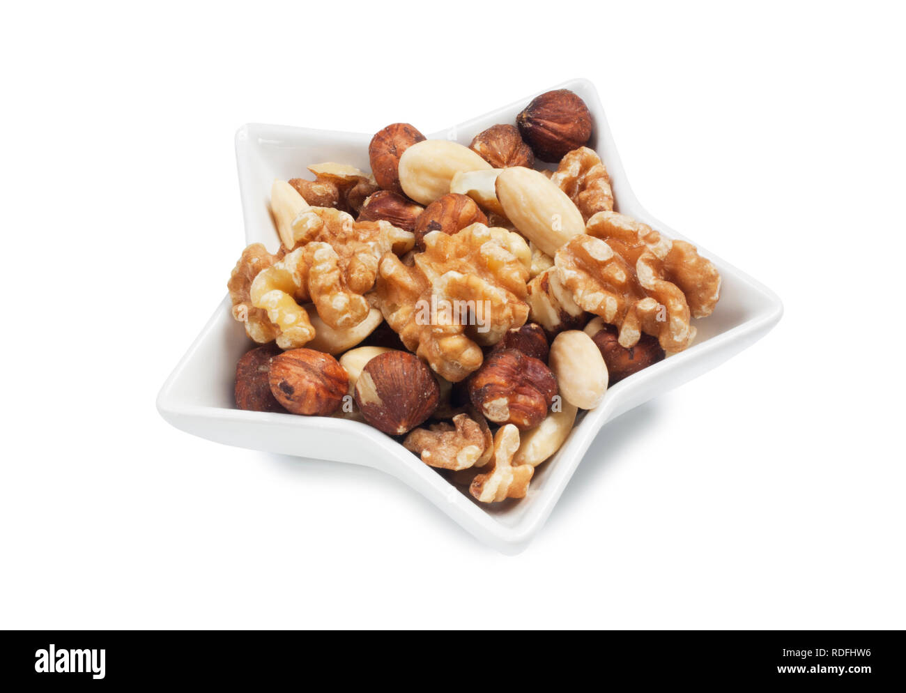 studio shot of mixed nuts isolated against a white background - John Gollop Stock Photo