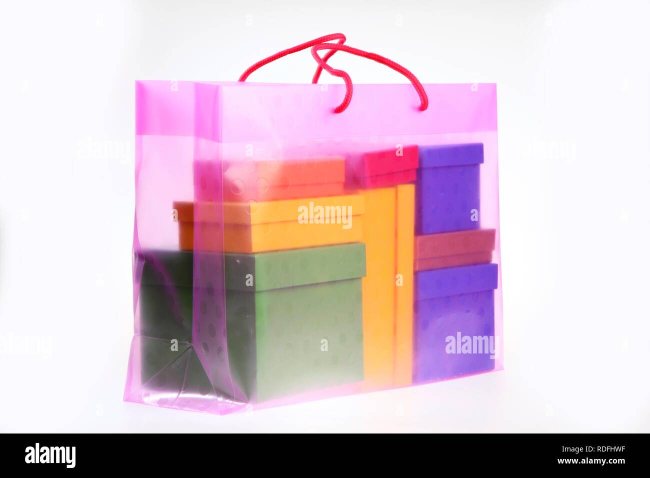 Clear plastic bag filled with colorful paper gift boxes Stock Photo Alamy