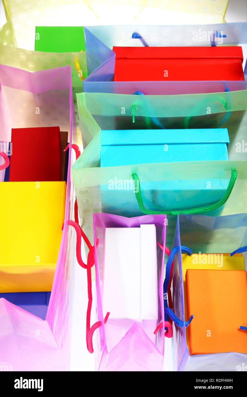 Clear plastic bag filled with colorful paper gift boxes Stock Photo Alamy