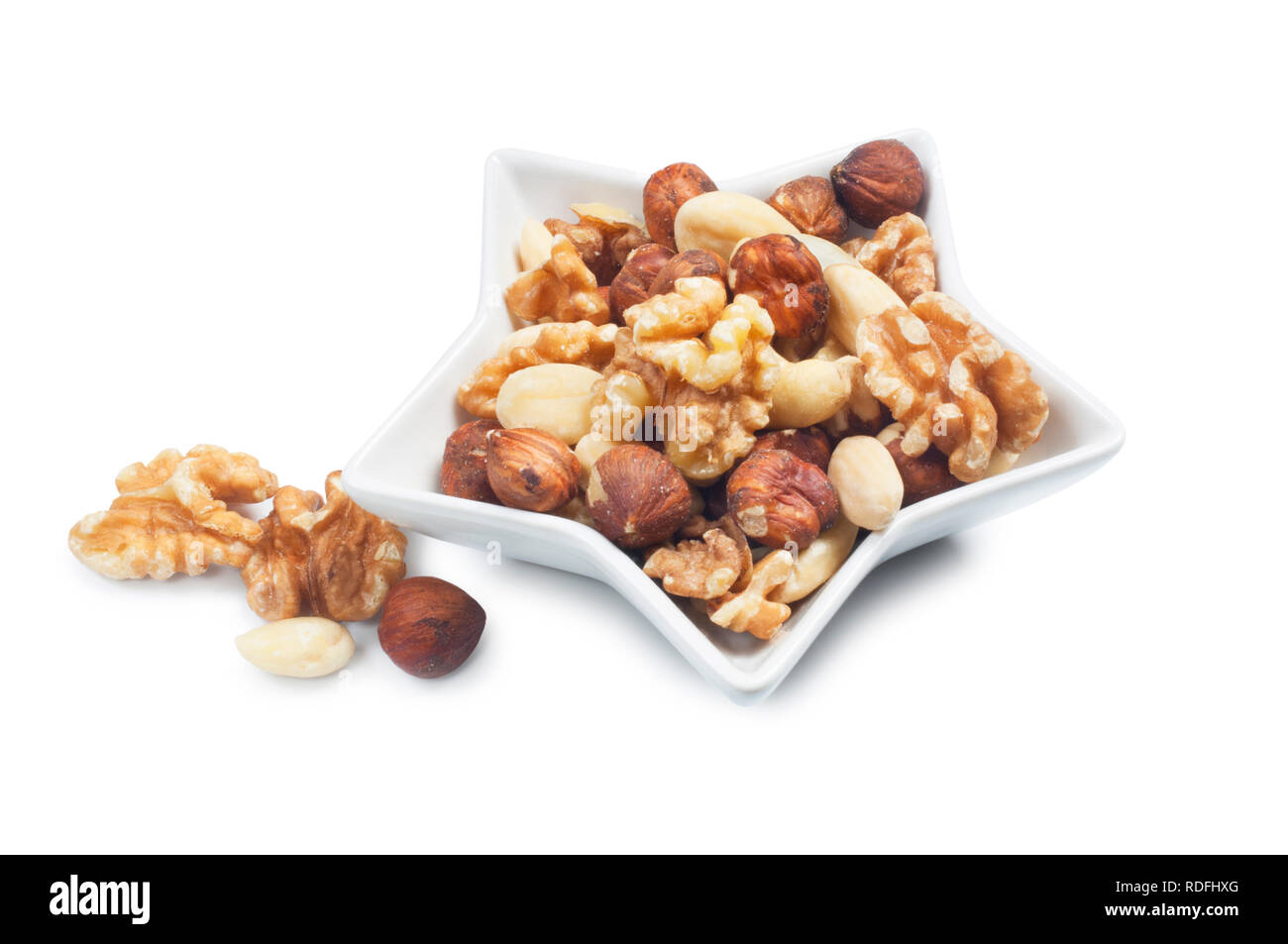 studio shot of mixed nuts isolated against a white background - John Gollop Stock Photo