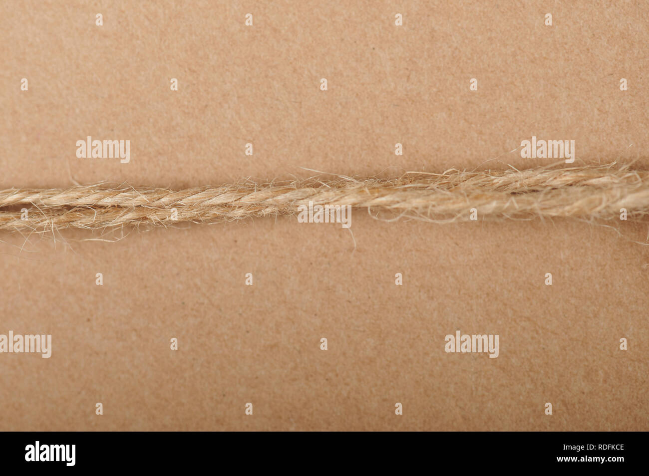 String brown rope close up view on brown paper background Stock Photo