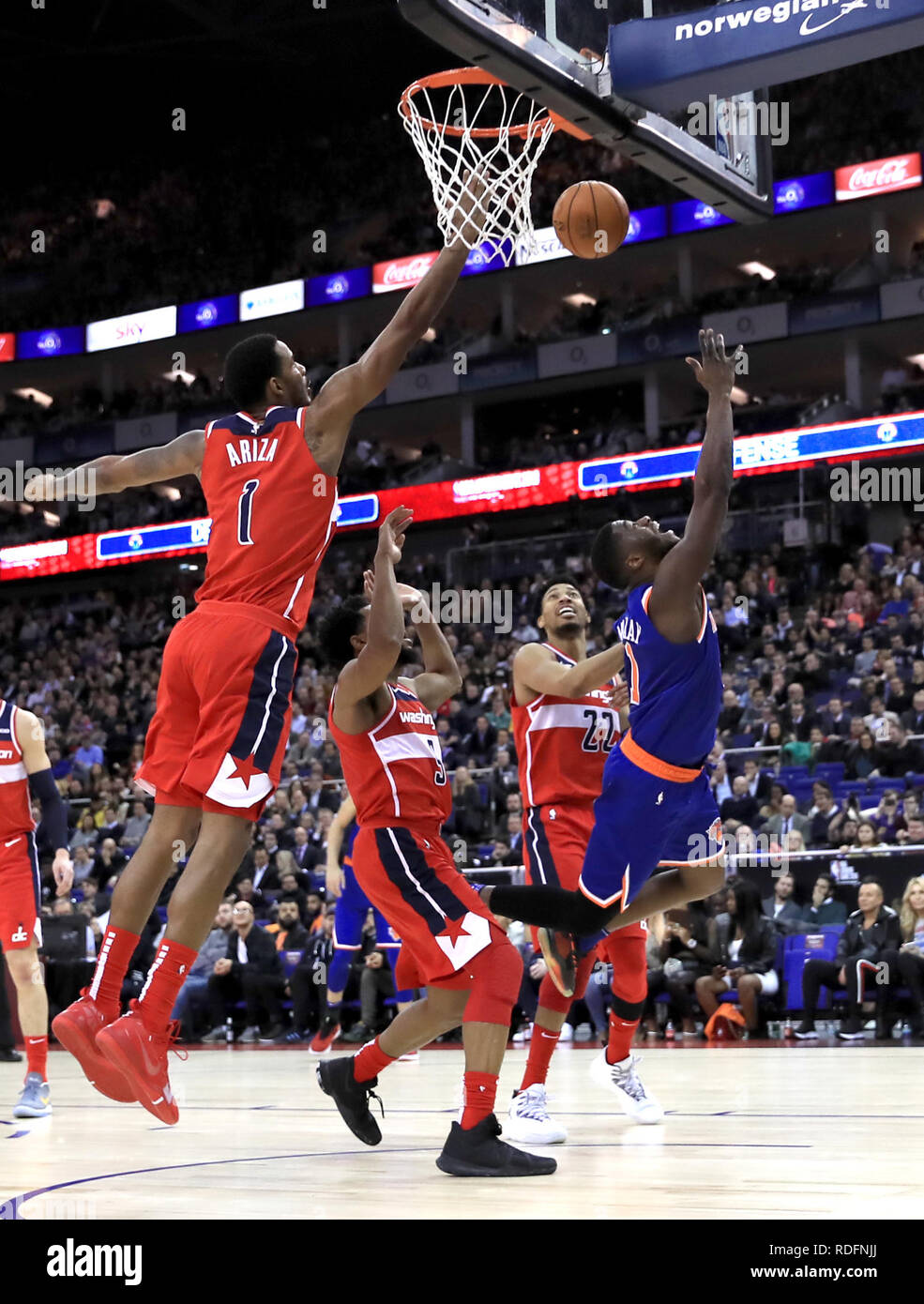 New York Knicks' Emmanuel Mudiay (right) dives for the basket during the NBA London Game 2019 at the O2 Arena, London. Stock Photo