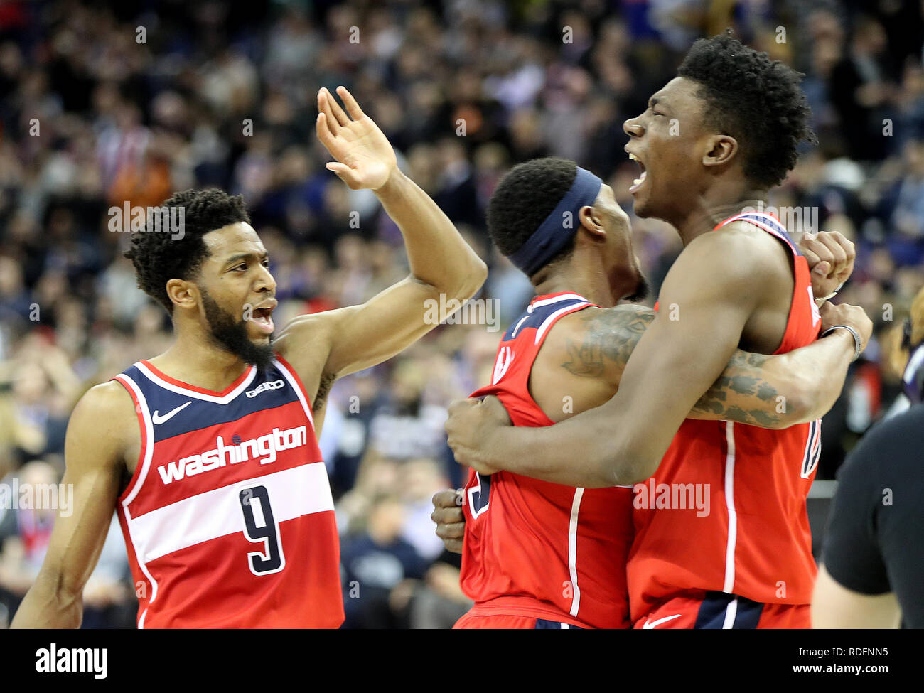Washington Wizards' Thomas Bryant (right) celebrates with team-mates Bradley Beal (centre) and Chasson Randle after the final whistle during the NBA London Game 2019 at the O2 Arena, London. Stock Photo