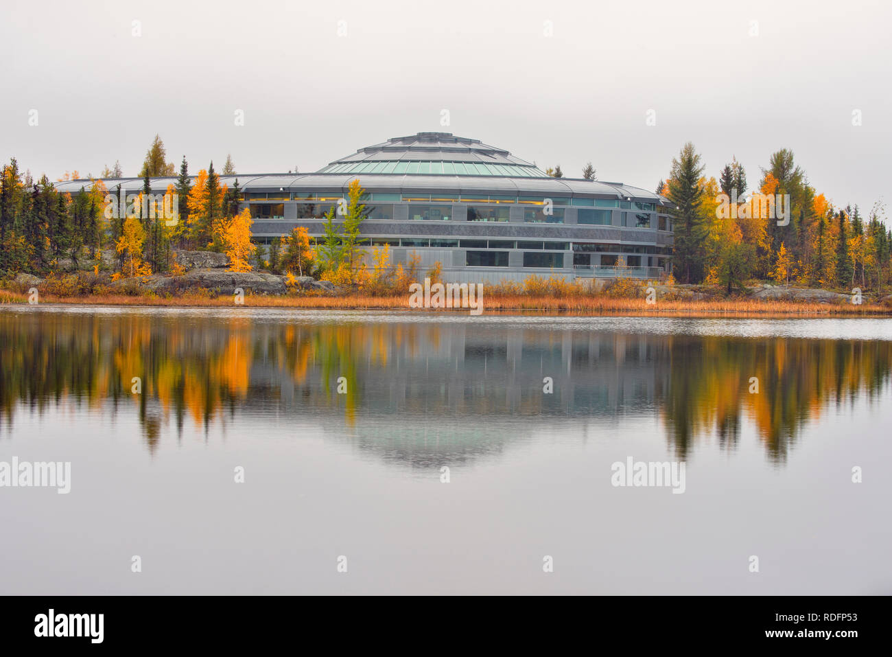 NWT Legislature reflected in Range Lake in autumn, Yellowknife, Northwest Territories, Canada Stock Photo