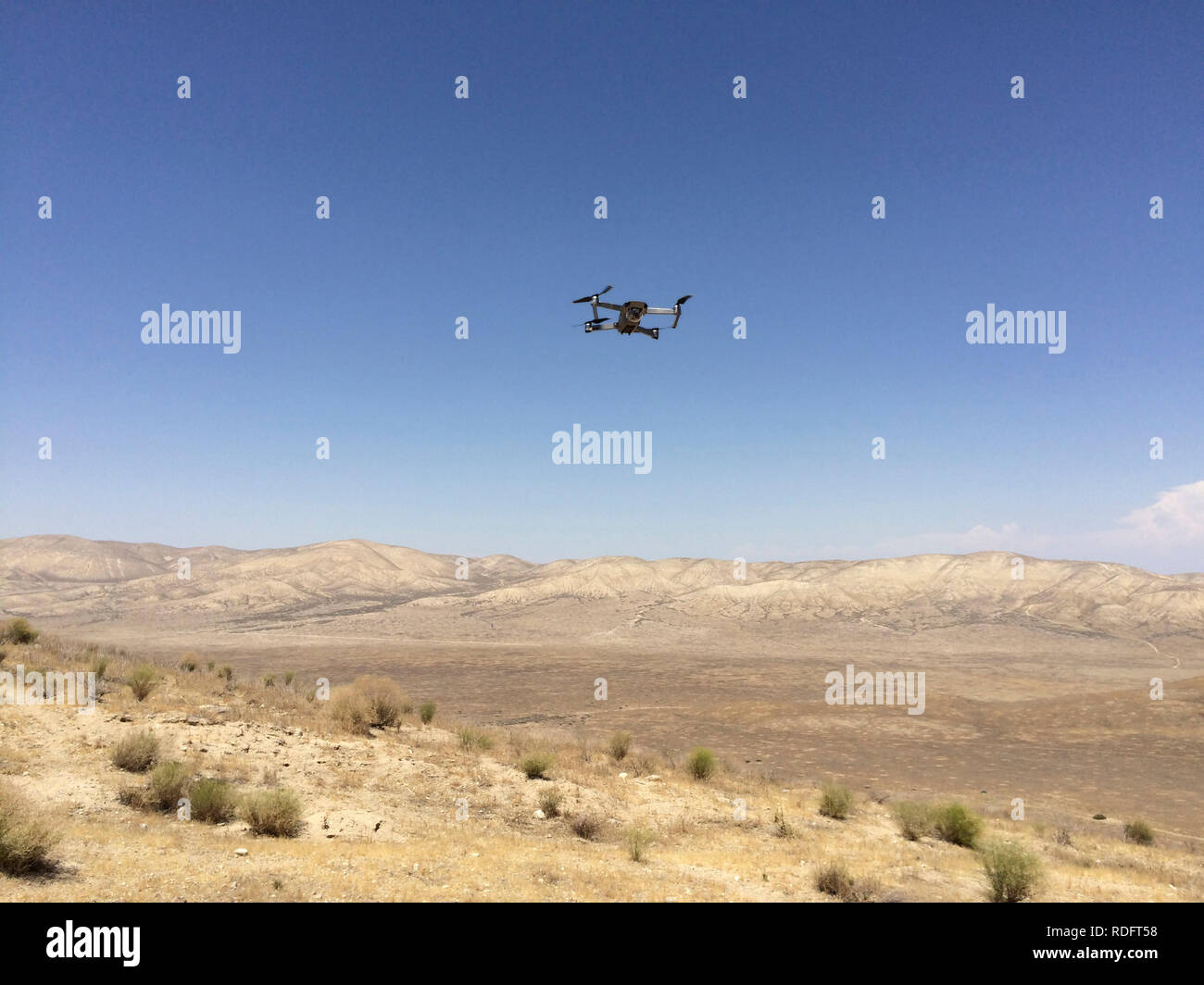DJI Mavic Pro drone hovering over desert landscape ( camera drone ) - California USA Stock Photo