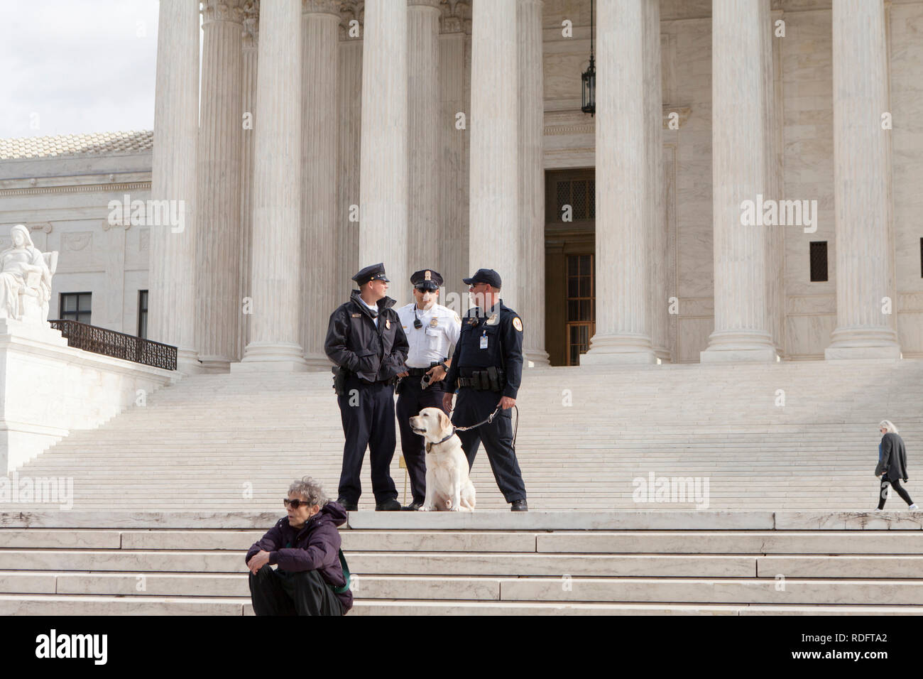 The Supreme Court Police, and police dog, standing at the front steps of the Court building - Washington, DC USA Stock Photo