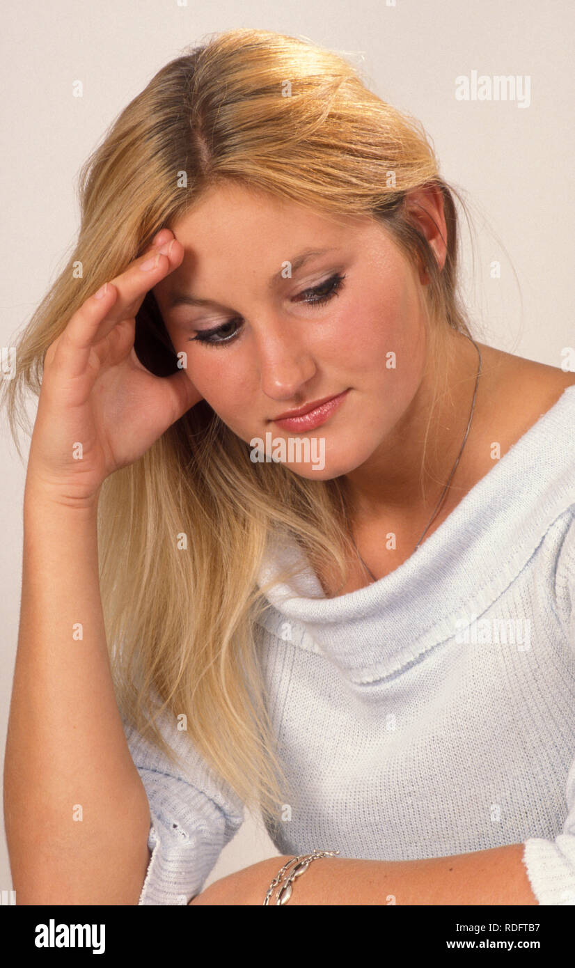 contemplative young blonde woman Stock Photo
