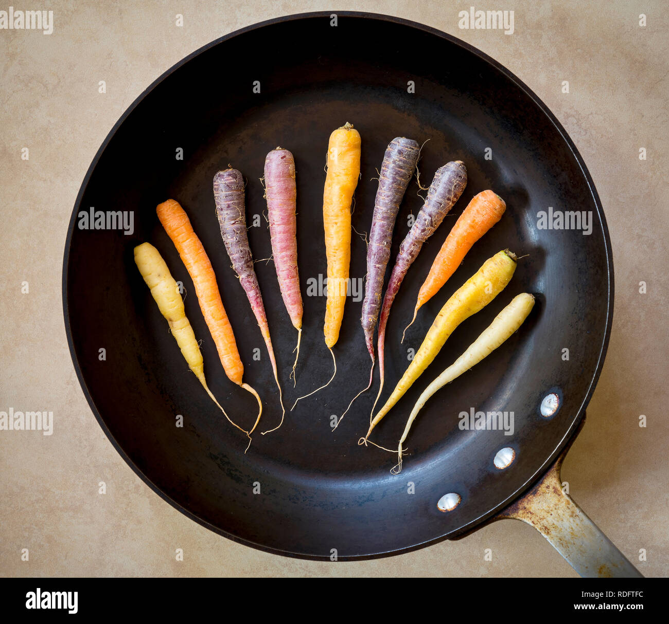 Colorful rainbow carrots in a dark roasting pan Stock Photo Alamy