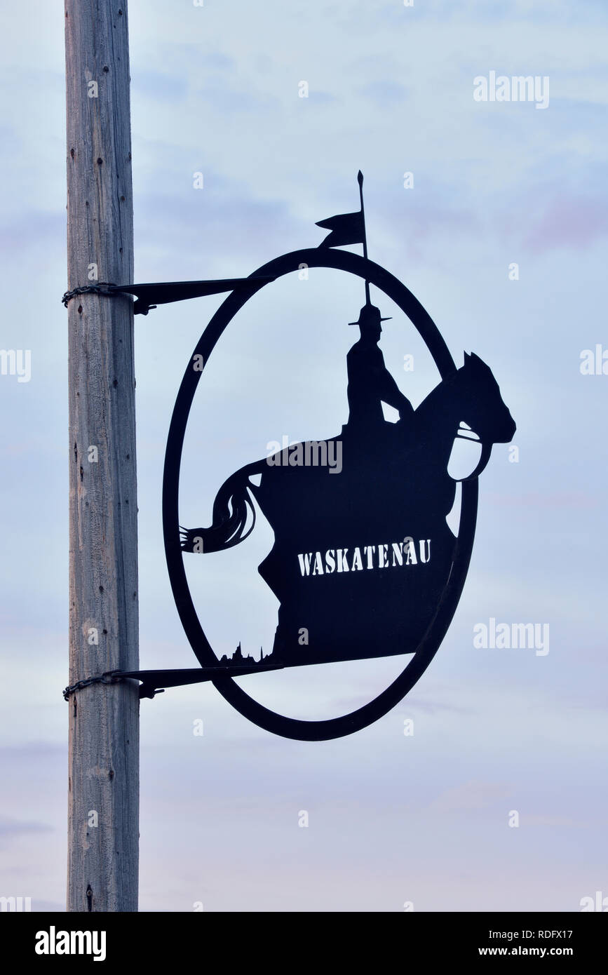 Decorative metal sculpture attached to street light poles, Waskatenau