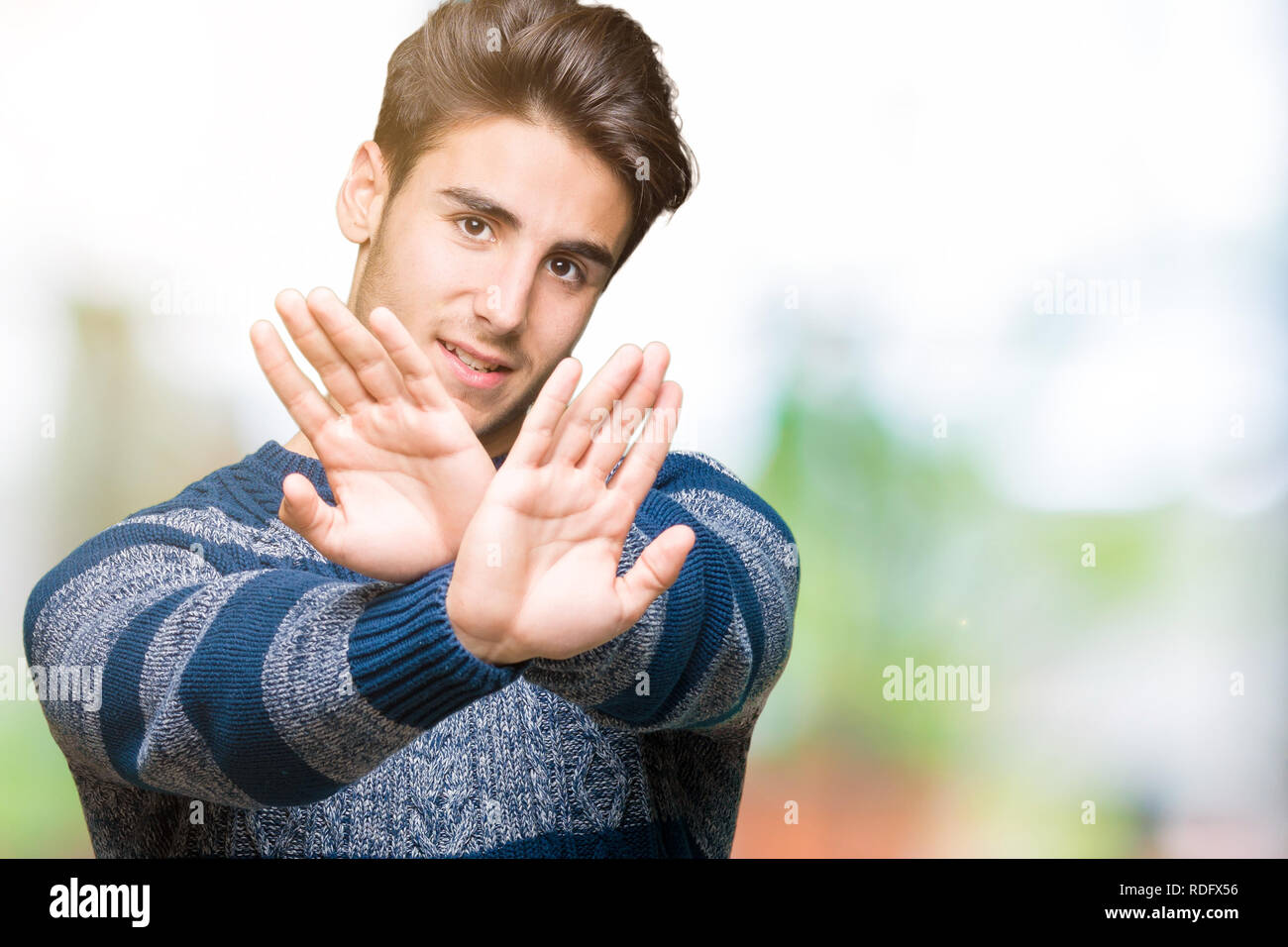 Young handsome man over isolated background Rejection expression ...